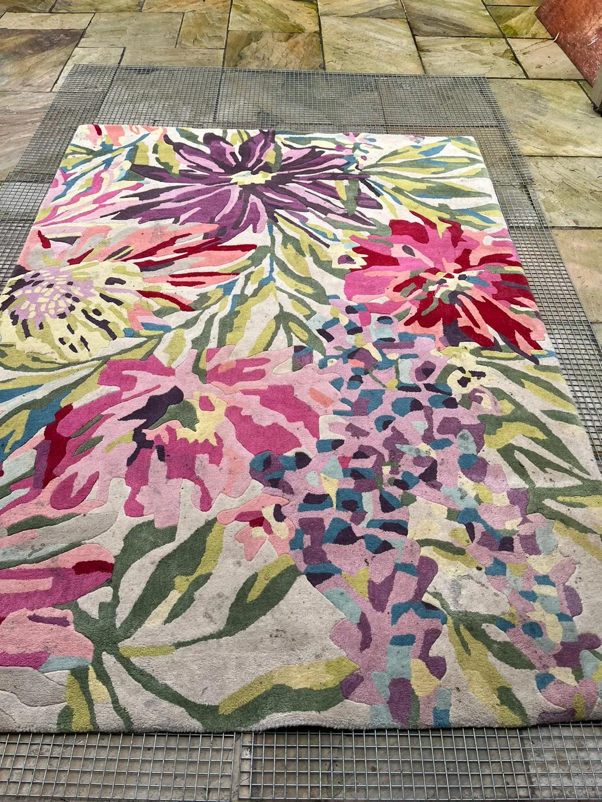 Machine-made wool rug before deep cleaning